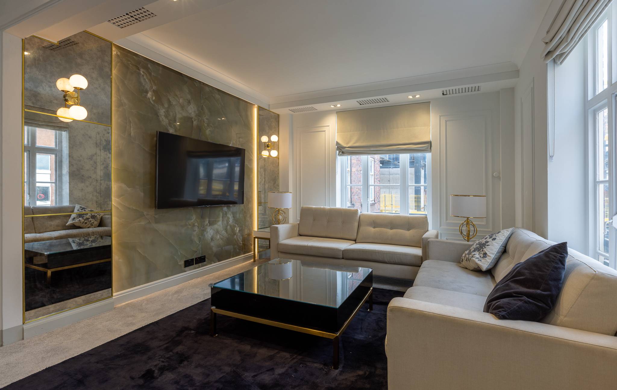 Living room of the Mayfair flat with a backlit onyx feature wall
