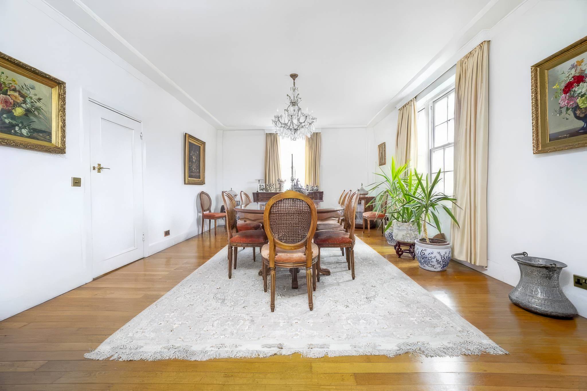 Dining room before the refurbishment, with a pendant chandelier, wooden floor and a rug