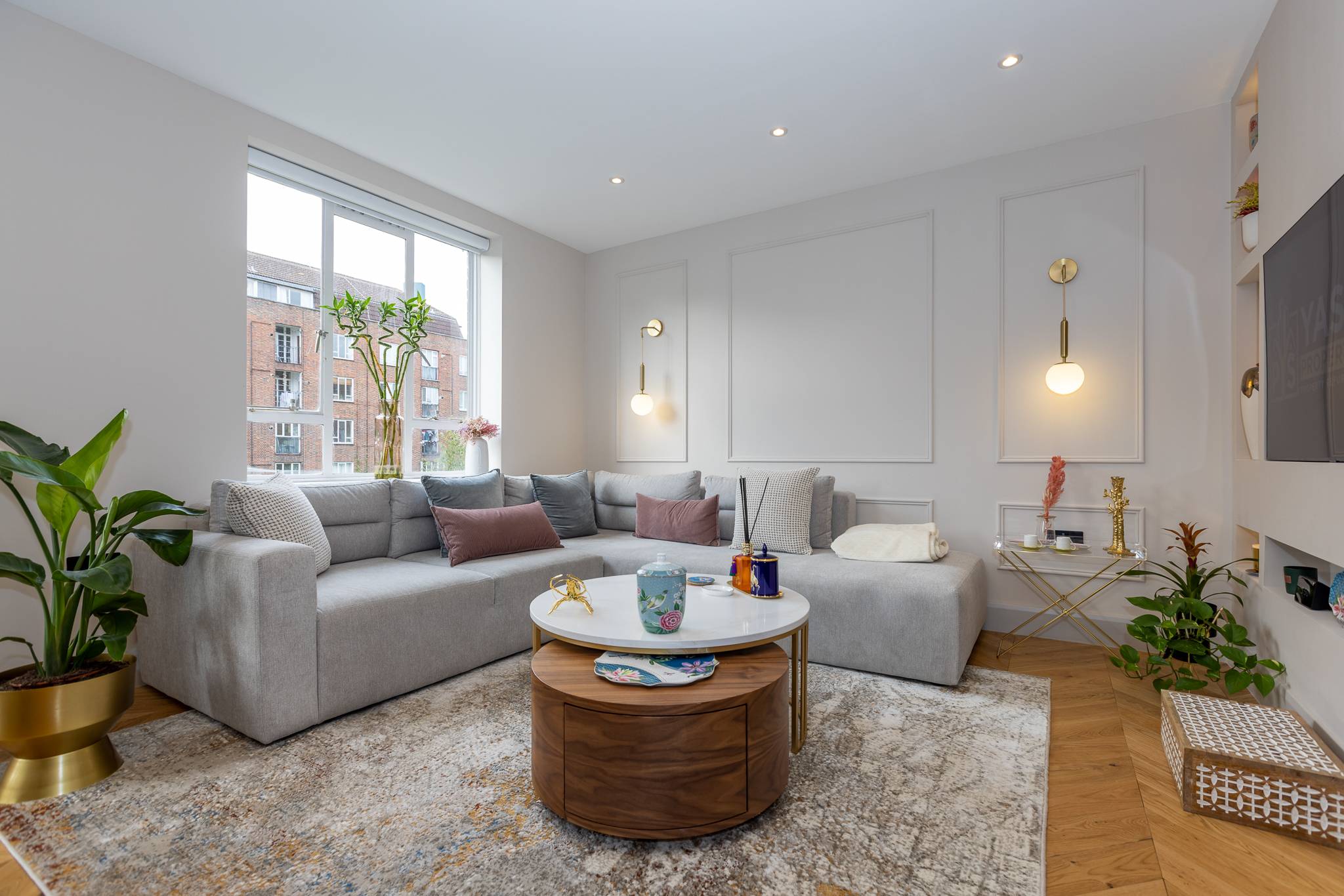 Wandsworth living room with a grey corner sofa and lit display niches